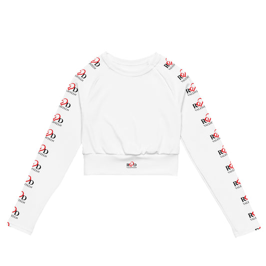 A white long-sleeve activewear crop top with an allover repeating red and black 'Red Valenteen' logo print down both sleeves and a small matching logo on the ribbed hem.
