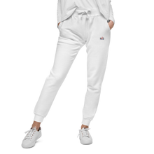Load image into Gallery viewer, Image of front view of white cotton gym pants in comfort style fit, displaying the fine embroided  Red Valenteen logo on the front left side at  hip level, teamed with cute white lace up sneakers and a tucked in white sweashirt