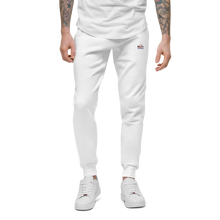 Load image into Gallery viewer, Image of a slim male model from the waist down wearing comfortable fit  luxury white cotton track pants with Red Valenteen logo on front left side at hip level, styled with a white loose tshirt and matching white sneakers