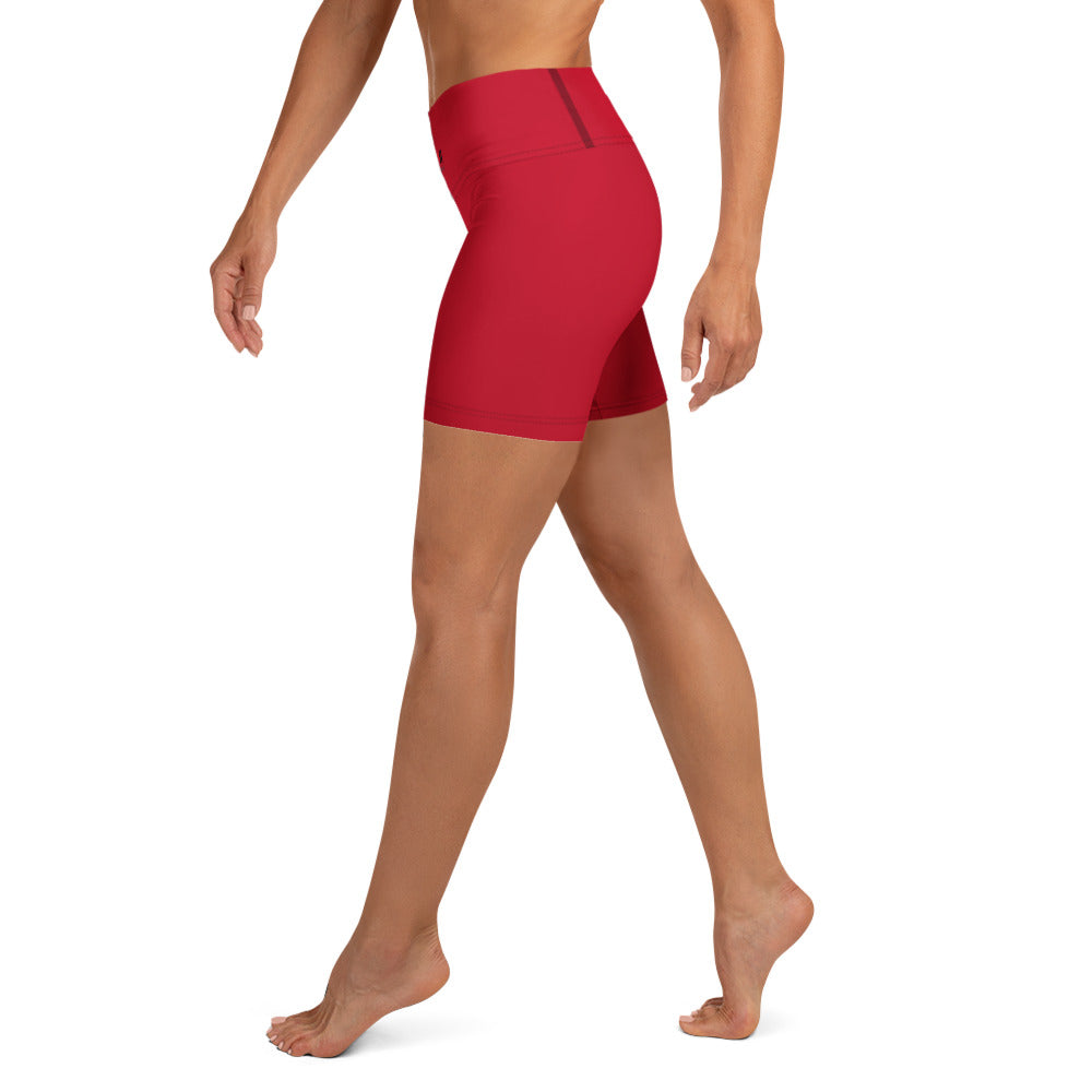 A model wearing bright red high-waisted athletic shorts, shown from a side-back angle against a plain white background.