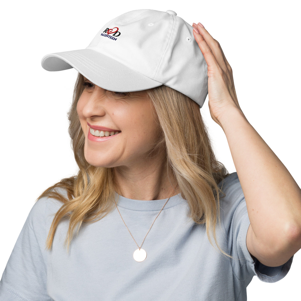 the left side view of a woman wearing the Red Valenteen logo white head cap, with blonde hair and a grey tshirt infront of a white background.