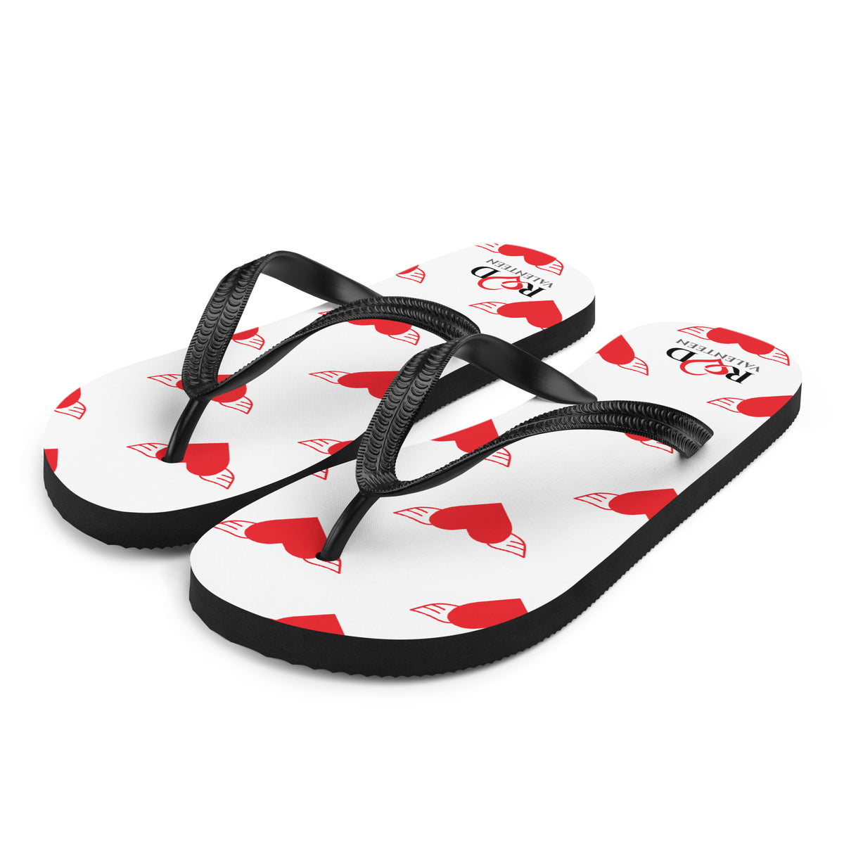 A pair of white flip-flop sandals with black straps and red heart-and-wing printed inlays on the footbeds, shown on a clean white background.