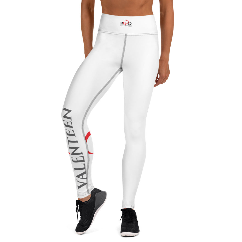 Image of the lower half of a model wearing Iconic Red Valenteen white leggings with bold dramatic Red Valenteen logo on one side of the lower leg showcasing a sleek and smooth fit paired with black runners for a dramatic look