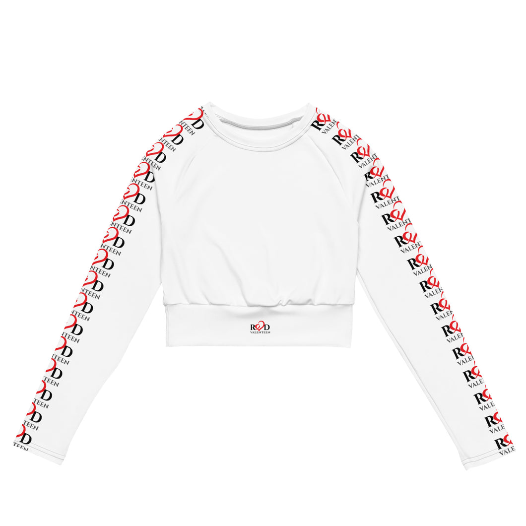 lay flat photo of luxury women's cropped white long sleeved active wear sports top with detailed repeat pattern logo on both the sleeves, in eyepopping red and black designed by Red Valenteen