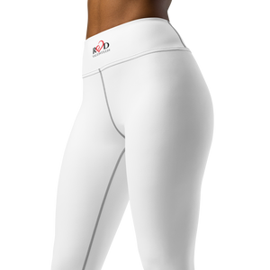 A close up image from the waist to the knees of a woman's white legging showcasing the sleek design and flattering style which includes the small Red Valenteen Logo on the high waist band.