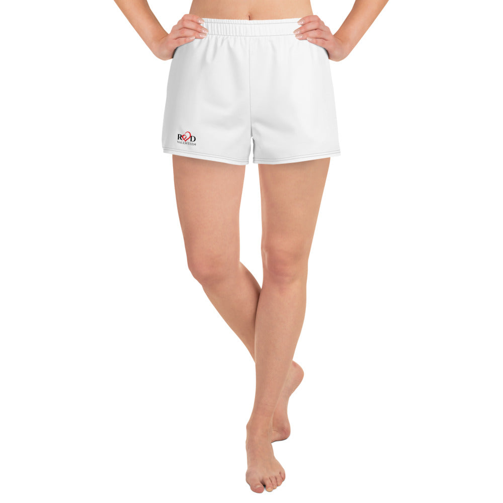 Front view image of model from waist down wearing a cute pair of white women's athletic running shorts, with contrast trim stitch, Red Valenteen logo on front right side, and two side pockets created with a breathable, light recycled material 